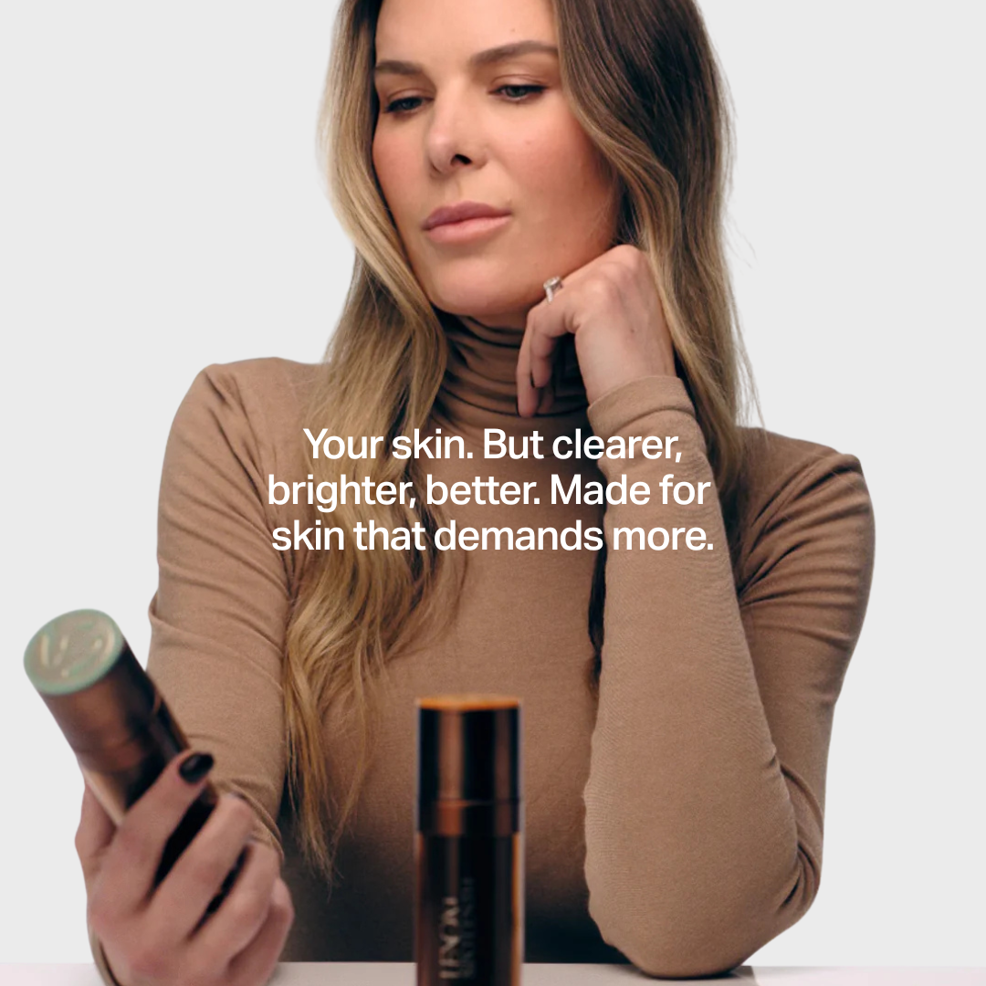 Person examining skincare product, focused setting. Text: