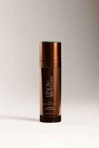 Bottle standing, labeled "Lenox Sixteenth," against a plain background. Text: "THE PRESERVATIONIST VITAMIN C CREAM SERUM 50 ML | 1.7 FL OZ."