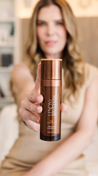 Bottle held by person, blurred background, room setting. Text: "LENOX AND SIXTEENTH, THE LASER SERUM, TRIPLE ACID CONCENTRATE, 50 ML 1.7 FL OZ."